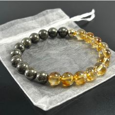 ❤️ Genuine Gemstone Stretchable Bracelet Made to Order with Pyrite and Citrine Crystals with 14K Gold Filled Accent Bead This Abundance Bracelet is a potent amulet for good fortune made of Citrine & Pyrite crystals, which give it metaphysical strength. When worn, it is supposed to attract wealth, success, and abundance to the wearer. PYRITE Pyrite is a powerful protection stone which shields and protects against all forms of negative vibrations and/or energy, working on the physical, etheric, an Pyrite Bracelet, Bracelet Gift Box, Zodiac Bracelet, Crystal Healing Bracelets, White Bracelets, Attract Wealth, Citrine Crystal, Amethyst Bracelet, Bracelet Argent