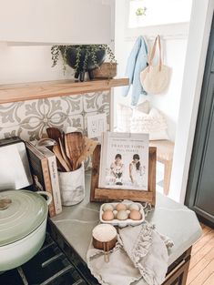 the kitchen counter has eggs and other cooking utensils on it, along with an old cookbook