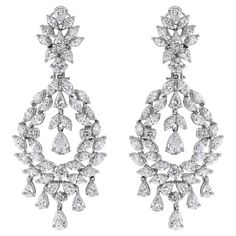 With timeless design and dazzling diamonds, these earrings are a showstopper. Diamonds Shapes: Round, Marquise & Pear Total Diamond Weight: 11.18 ct Diamond Color: G - H Diamond Clarity: VS (Very Slightly Included) Metal: 18K White Gold Metal Wt: 26 gms Setting: Prong Set Length: 2.5 Inches (6.35 cm) Non Threaded Post + Omega Back & Push Back Closure Luxury Pear-shaped Chandelier Earrings For Formal Events, Hand Set Diamond White Earrings For Evening, Formal Diamond White Chandelier Earrings With Brilliant Cut, Dazzling Diamond Chandelier Earrings For Formal Occasions, Formal Chandelier Earrings With Brilliant Cut Cubic Zirconia, Glamorous Brilliant Cut Bridal Earrings For Formal Occasions, Glamorous Brilliant-cut Bridal Earrings For Formal Occasions, Glamorous Brilliant Cut Bridal Earrings For Formal, Formal Diamond Chandelier Earrings With Prong Setting