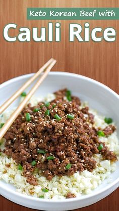 a white bowl filled with rice and meat next to chopsticks