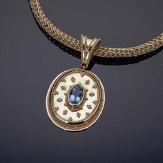 This Aquamarine Granulated Pendant is a fine example of handcrafted jewelry. Meticulously crafted in 18K gold, it features a stunning 1.09ct oval-cut aquamarine and exquisite granulation, making it an eye-catching piece of accessory. A luxurious adornment and timeless statement piece. Dimensions: 1-1/2" x 7/8" (38mm x 24mm) including bail(Necklace sold separately) Collectible Gemstone Oval Pendant Jewelry, Aquamarine Gemstone Pendant Jewelry, Aquamarine Round Pendant Gemstone Jewelry, Luxury Handmade Aquamarine Necklace, Luxury Aquamarine Pendant Jewelry, Oval Cut, Aquamarine, Handcrafted Jewelry, 18k Gold