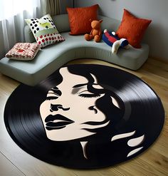 a black and white photo of a woman's face on a vinyl record rug