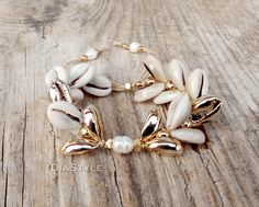 This beautiful cowrie shell bracelet is made with natural beige cowrie shells, natural gold cowrie shells, gold plated beads, natural pearls and beige silk cord. Bead size: shell 1,5 - 2 cm / 0,6 - 0,8 inch.; gold plated beads 0,3 cm /0,1 inch. Your bracelet comes gift wrapped and shipped via priority registered air mail with tracking info available. Feel free to ask me any questions! Thanks for visiting and happy shopping :) Cowrie Shell Bracelet, Cowrie Shell Jewelry, Neon Bracelets, Double Bracelet, Beige Silk, Cowrie Shells, Jewelry Beach, Jewelry Summer, Shell Bracelet