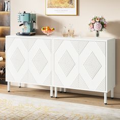 a white cabinet in a living room next to a book shelf