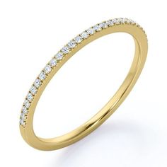 a yellow gold wedding ring with rows of diamonds on the side, set against a white background