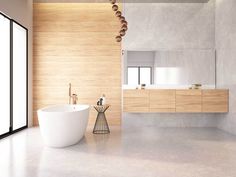 a bathroom with a large white bathtub next to a sink