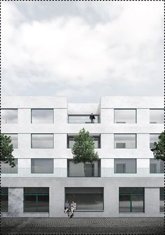 two people are walking in front of a white building with windows and balconies