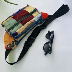 These patchwork fanny packs are made from smaller pieces of fabric extras. Quilted together. They are your perfect companion when you travel. Can hold your phone, wallet, passport, all essentials.  Wear it around your shoulder like a sling bag or around your waist while you hike or go on a trek, this fanny pack won't let you down. Has cushioning as well so that you don't find it heavy. Insides are made with upcycled polyester lining Has 3 compartments, with a secret zipper pocket inside It is patchwork, so images are just a representation. The final product might differ from the ones in the photos Multicolor Rectangular Belt Bag For Everyday Use, Multicolor Rectangular Belt Bag, Casual Multicolor Rectangular Belt Bag, Multicolor Zipper Pouch Belt Bag For Travel, Multicolor Belt Bag With Zipper Pocket For Daily Use, Multicolor Belt Bag With Pockets For Everyday Use, Multicolor Belt Bag With Zipper Pocket, Multicolor Rectangular Belt Bag With Cell Phone Pocket, Corduroy Sling Bag