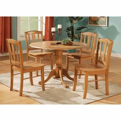 a dining room table with four chairs around it