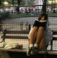 a person sitting on a bench reading a book