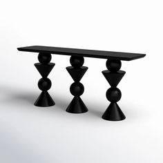 three black candlesticks sitting next to each other