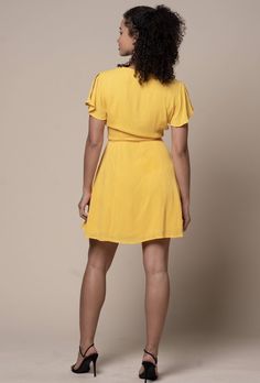 Celebrate the day with this flirty honey yellow wrap dress. Made of a gauzy rayon material, fully lined & finished with an adjustable waist tie sash. 75% Rayon / 20% Nylon / 5% Spandex Made In Vietnam Flowy Belted Wrap Dress, Flowy Belted Wrap Dress With Surplice Neckline, Flirty Mini Wrap Dress With Tie Waist, Flirty Mini Length Wrap Dress With Tie Waist, Flirty Spring Wrap Dress With Tie Waist, Flirty Tie Waist Wrap Dress For Brunch, Flirty Tie Waist Wrap Dress For Date Night, Summer Mini Length Belted Dress For Date Night, Summer Mini Belted Dress For Date Night