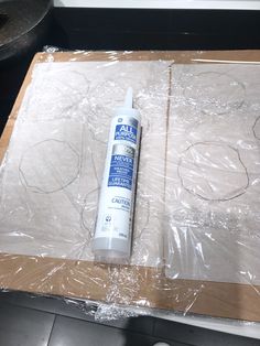 a bottle of glue sitting on top of a cardboard box