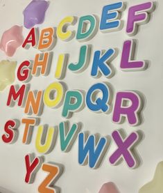 the letters are made out of plastic and have different colors, shapes, and sizes