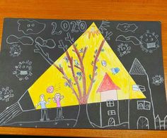 a child's drawing of a house and tree on a blackboard with chalk