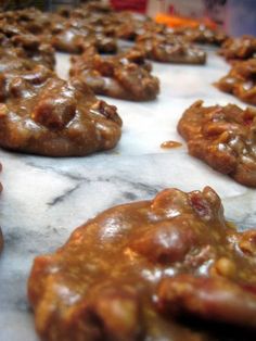 several cookies are lined up on a marble counter top, ready to be baked or eaten