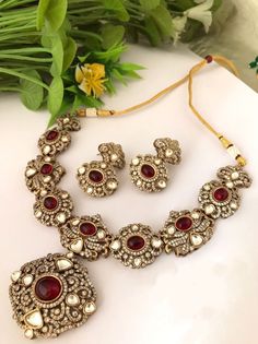 Fine Quality Sabyasachi inspired Victorian style kundan Polki Necklace with matching Earrings. Highest quality and craftsmanship Free shipping Since natural semiprecious beads are used in this necklace, Color and shape of the beads may vary slightly Please let me know if you have any questions Handmade Gold Kundan Set, Handmade Kundan Gold Sets, Handmade Gold Kundan Jewelry Set, Handmade Kundan Gold Jewelry Set, Bohemian Kundan Jewelry Sets With Stone Work, Bohemian Kundan Necklace With Intricate Design For Wedding, Ornate Hand Set Kundan Necklace For Celebration, Ornate Hand-set Kundan Necklace For Celebration, Ornate Kundan Necklace For Celebration