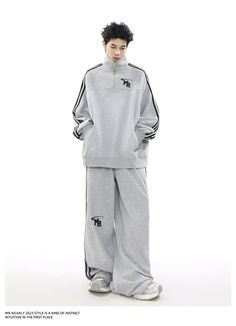 The "Urban Edge Athleisure Set" offers a stylish blend of comfort and street style. Featuring a soft grey zip-up jacket with a subtle chest emblem and matching drawstring pants with sleek side stripes. This tracksuit is perfect for versatile, everyday wear. Gray Tracksuit For Winter Streetwear, Gray Winter Tracksuit For Streetwear, Gray Athleisure Tracksuit For Leisure, Gray Winter Tracksuit Sportswear, Gray Relaxed Fit Sportswear Tracksuit, Gray Sporty Winter Tracksuit, Gray Casual Tracksuit For Streetwear, Gray Tracksuit With Ribbed Cuffs For Loungewear, Sporty Gray Long Sleeve Tracksuit