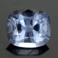 an oval shaped blue diamond on a white surface