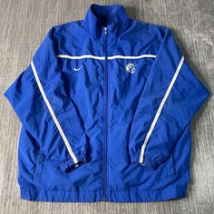 Vintage 2000s Nike Swoosh Check Two Pocket Sportswear Athletic Y2K Aesthetic Blue Zip Up Track Jacket Double Extra Large Mens Condition:  Excellent Used Condition  = No Flaws Measurements: Please see photos above for all measurements IF YOU BUY TWO OR MORE ITEMS USE THE CODE BUNDLE @ CHECK TO SAVE 20% WE SHIP WITHIN 24 HOURS AFTER PURCHASE! Please be aware that we do not offer free returns!! The Buyer is responsible for the cost of the return label.  Follow us on TikTok & Instagram @findsnostalg Y2k Nike Jacket, Cheap Men's Blue Track Jacket, Sporty Windbreaker For College Sports Season, Blue Collegiate Track Jacket For Sports Events, Collegiate Blue Sports Outerwear, Collegiate Blue Outerwear For Sports, Blue Sportswear Outerwear For College, Blue Sportswear Outerwear, Blue Sportswear Track Jacket For Gym