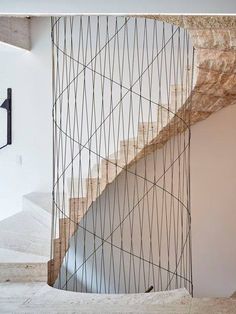 a spiral staircase in a house with white walls