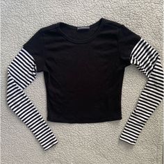 : About The Item : Item : Brandy Melville Black Long Sleeve Top Color : Black With Striped Black And White Sleeves Size : One Size ~ Although "One Size" Fits An Xs-M Condition : Like New ~ Looks Completely Brand New! : Tags : Pacsun , Pacsun , Pacsun Top , Pacsun Top , Pacsun Long Sleeve Top , Long Sleeve Top , Brandy Melville , Brandy Melville , Brandy Melville Top , Brandy Melville Long Sleeve Top , Brandy Melville Long Sleeve , Brandy Melville Top , Brandy Melville Long Sleeve Top , Emo , Gru Long Sleeve Tops With Contrast Stripes For Spring, Stretch Crew Neck Top With Contrast Stripes, Fitted Tops With Contrast Stripes For Spring, Fitted Spring Tops With Contrast Stripes, White Stretch Tops With Contrast Stripes, Black Fitted Top With Contrast Stripes, Fitted Crew Neck Top With Contrast Stripes, Fitted Black Top With Contrast Stripes, Casual Fitted Top With Contrast Stripes