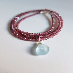 "This stunning piece  is made of tiny, genuine rhodolite garnet gemstones and one  beautiful aquamarine briolette.  I've used an unusual combination of colors. The necklace closes at  cm, 43,00  16.92\"-  The clasp and  findings are 925 silver, I can add an extender chain  It's beautiful and dramatic, still versatile for every day wear you will receive the exact necklace shown in the photos  see the matching earrings here  https://www.etsy.com/listing/525102226/rhodolite-garnet-earringsaquamarin Luxury Briolette Jewelry With Sterling Silver Clasp, Garnet Briolette Beads For Jewelry Making, Garnet Briolette For Jewelry Making, Aquamarine Faceted Briolette Jewelry, Aquamarine Briolette Faceted Jewelry, Faceted Briolette Garnet Jewelry, Briolette Faceted Aquamarine Jewelry, Layered Chokers, Aquamarine Pendant