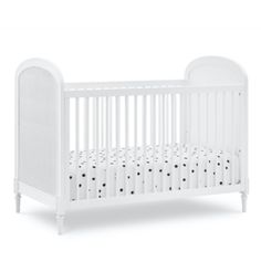 a white crib with black dots on it