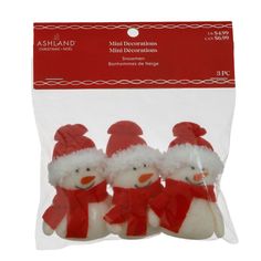 three snowmen in red hats and scarfs are packaged in plastic bags for christmas