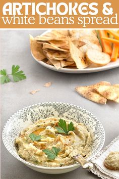 artichokes and white beans spread in a bowl with crackers on the side