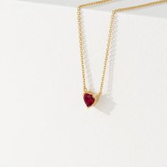 Corin Ruby is a stone of royalty, highly coveted for its rich red hue. This ruby was meticulously cut into the most subtle of hearts so you can wear it every day. It layers well with other dainty necklaces, and alone it almost looks like it is floating on your neck. This is the perfect gift for a girlfriend, daughter, granddaughter or even bridesmaid. - Handmade- Solid Gold- Natural Ruby- Pendant Size: 5 mm- Total Ruby Carat Weight: .40 ctw All Sarah Elise ruby jewelry come beautifully boxed in Ruby Heart Necklace, Ruby Heart, Dainty Necklaces, Handmade Fine Jewelry, Ruby Pendant, Emerald Pendant, Ruby Jewelry, White Gift Boxes, Natural Ruby