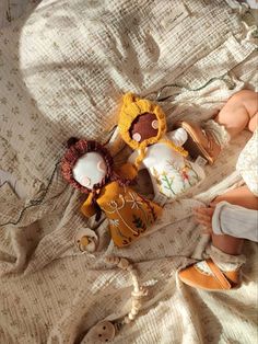 two stuffed animals laying on top of a bed next to a baby's diaper