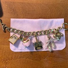 Juicy Couture Charm Bracelet Complete With Diary, Cupid, Movie, Ballet, And Gold Heart Charms. Bracelet Itself Is In Very Good Condition, A Couplep Of The Charms (Cupid And Ballet) Have Very Noticeable Wear (Caused Mostly By Washing Hands). Could Be Refurbished With The Right Loving Owner! :) Other Charms In Good Condition With No Noticeable Imperfections. Would Be Willing To Sell Charms/Bracelet Separately If Needed, But Ideally Would Sell Together. Elegant Metal Charm Bracelet With Removable Charms, Elegant Metal Charm Bracelet With Logo Charm, Elegant Bracelets With Charms As Fashion Accessory, Elegant Bracelets With Charms, Designer Pink Bracelets For Gift, Designer Pink Bracelets As Gift, Designer Pink Bracelet For Gifts, Pink Metal Charm Bracelet With Removable Charms, Elegant Pink Jewelry As Fashion Accessory