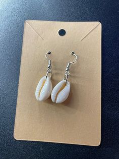 Cute sea shell earrings White Shell-shaped Shell Jewelry, Casual Shell Jewelry Gift, Silver Shell With Ocean-inspired Style For Vacation, Nickel-free Shell Gift, Single Dangle Earring For Beach, Silver Ocean-inspired Shell For Vacation, White Shell Drop Earrings For Summer, Beach Drop Clip-on Earrings, White Shell-shaped Ocean-inspired Jewelry