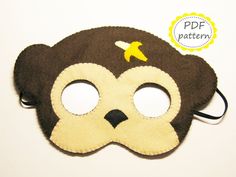 a brown monkey mask with yellow stars on it's forehead and eyes are shown in front of a white background