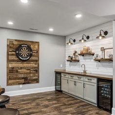 a kitchen with wood flooring and white walls, along with an overhead dart board on the wall