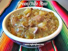 green chile stew in a white bowl on a colorful table cloth with text overlay