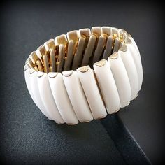 Vintage white thermoset Wide expandable bracelet Vintage gold white cuff bracelet small size 6 1/2'' Metal - Gold-tone Ston: white thermoset panels Size -  small 6 1/4'', wide1 1/4'' Mark - Hong Kong Around the 1950s -1960s Condition - good condition PLEASE NOTE: Vintage jewelry can show signs of wear and discoloration or chipped metal consistent with age. Please look at the pictures carefully. Most were purchased at estate sales, auctions, etc. so they could need cleaning. If you need additional pictures or have questions, please contact me prior to purchase. I am not a jeweler or an expert. I do the best I can to research and represent the items. Also on auction purchases, I use the information I get from the auction houses. If you have any questions or need additional pictures, please l Flexible White Bangle Bracelet, White Flexible Bracelet For Formal Occasions, White Adjustable Flexible Bracelets, White Adjustable Cuff Bracelet For Formal Occasions, Adjustable Flexible White Bracelets, Adjustable White Flexible Bracelets, White Adjustable Bangle Cuff Bracelet, Adjustable White Cuff Bangle Bracelet, White Bangle Cuff Bracelet For Formal Occasions