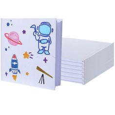 a set of four notebooks with space drawings on them