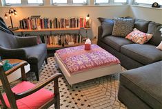 a living room filled with furniture and bookshelves