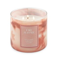 a candle that is sitting in front of a white background with the words fall flame on it