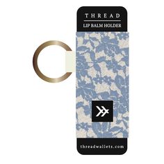 a keychain with a blue and white lace pattern on it, next to the logo for threaded