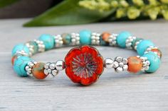 Blue and Orange Hippie Bracelet | by StoneRiverJewelry Hippie Bracelet, Hippie Bracelets, Colored Stone, Orange And Turquoise, Turquoise Howlite, Natural Gifts, Blue And Orange, Flower Bracelet, Nature Bracelets