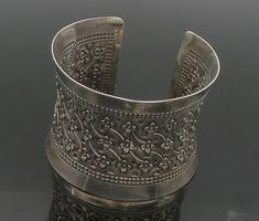 925 Sterling Silver - Vintage Flower Patterned Dark Tone Cuff Bracelet - BT7318  925 Sterling Silver - Vintage Flower Patterned Dark Tone Cuff Bracelet - BT7318  Jewelry Type:         Bracelet   Metal Type:            925 Silver  Metal Size:             6.75" Length  2" Height   Stone Type:            N/A  Condition:              N/A  Jewelry Weight:     67.8 Grams  PLEASE NOTE: THIS ITEM IS PRE-OWNED. ALTHOUGH MOST ITEMS ARE IN VERY GOOD CONDITION, SOME MAY NEED CLEANING AND/OR MINOR REPAIRS. WE MAKE A VERY STRONG EFFORT TO UPLOAD CLEAR PICTURES. PLEASE INSPECT ALL PICTURES AND ASK ALL QUESTIONS YOU MAY HAVE PRIOR TO MAKING A PURCHASE. NOT ALL STONES ARE GENUINE, SOME ARE ENHANCED OR CREATED. Luxury Ornate Sterling Silver Bangle, Luxury Victorian Sterling Silver Bracelet, Luxury Antique Style Sterling Silver Bangle, Funky Jewellery, Clear Pictures, Jewelry Aesthetic, Bracelet Metal, Funky Jewelry, Metal Bracelets