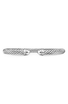 A cable-spiraled texture brings David Yurman's signature aesthetic to this sterling silver cuff bracelet ringed with pavé diamonds at the tips. 1/8" width Total diamond weight: 0.07ct. Sterling silver/diamond Imported >Diamond Guide Signature Aesthetic, Cable Bracelets, Diamond Guide, Sterling Silver Cuff Bracelet, Unisex Jewelry, Sterling Silver Cuff, Silver Cuff Bracelet, Silver Cuff, David Yurman