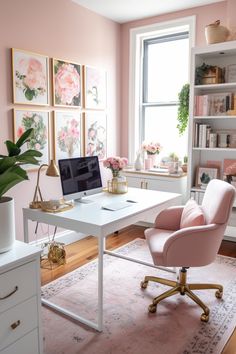 a home office with pink walls and white desks, gold accents and flowers on the window sill