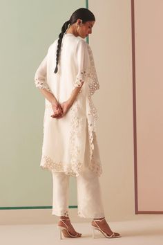 Ivory silk organza kurta with tonal beads and cutwork embroidery.
Components: 1
Pattern: Embroidered
Type Of Work: Beads, Cutwork
Neckline: Round
Sleeve Type: Flared Sleeves
Fabric: Silk organza, Lining : 100% Cotton
Color: Ivory
Other Details: 
Model Height : 5 ft 6 inches, wearing size S
Note : Pant worn by the model is not for sale.
Occasion: Sangeet - Aza Fashions Elegant Off White Sets With Intricate Embroidery, Elegant Off-white Sets With Intricate Embroidery, Elegant Lace Sets With Dupatta, Cream Organza Sets With Lace Work, White Organza Sets With Lace Work, Elegant Cream Sets With Lace Work, Elegant Off White Dupatta With Pearl Embroidery, Elegant Organza Sets With Lace Work, Elegant Lace Designer Wear Sets