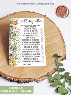 a printable wedding game with flowers and greenery on the table next to it