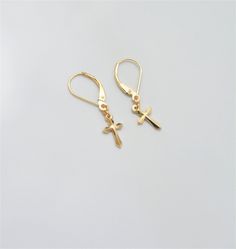 "Solid 14K Gold dangle earrings with cross charm - unisex earrings, mens earrings, womens earrings. These are simple and clean earrings featuring 13 mm cross charm. Cross charm has a beautiful cut creating \"3D\" effect and adding interest to the simple minimalist style of the earrings. These dangle earrings have a smooth reflective finish and secure lever back closure. They are lightweight, very comfortable to wear, and have a trendy modern look. Extra links at the top of the cross charms allow Minimalist Cross Pendant Earrings, Minimalist Gold Cross Earrings, Gold Hypoallergenic Cross Earrings, Minimalist Hypoallergenic Cross Earrings, Gold Cross Hypoallergenic Earrings, Nickel-free Gold Cross Earrings, Gold Nickel-free Cross Earrings, Yellow Gold Cross Earrings For Pierced Ears, 14k Gold Cross Earrings