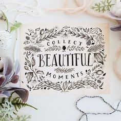 an art print with the words collect beautiful moments on it next to flowers and other items